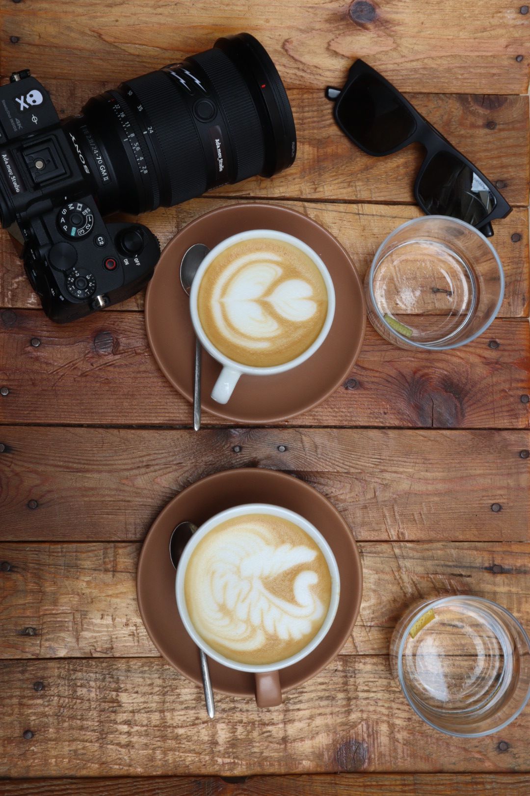Coffee and camera on wooden table