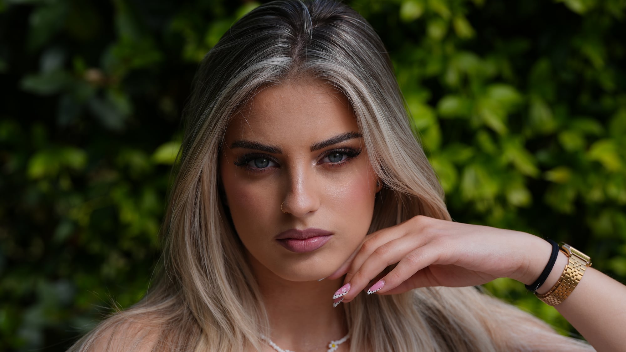 Portrait in natural light against green foliage