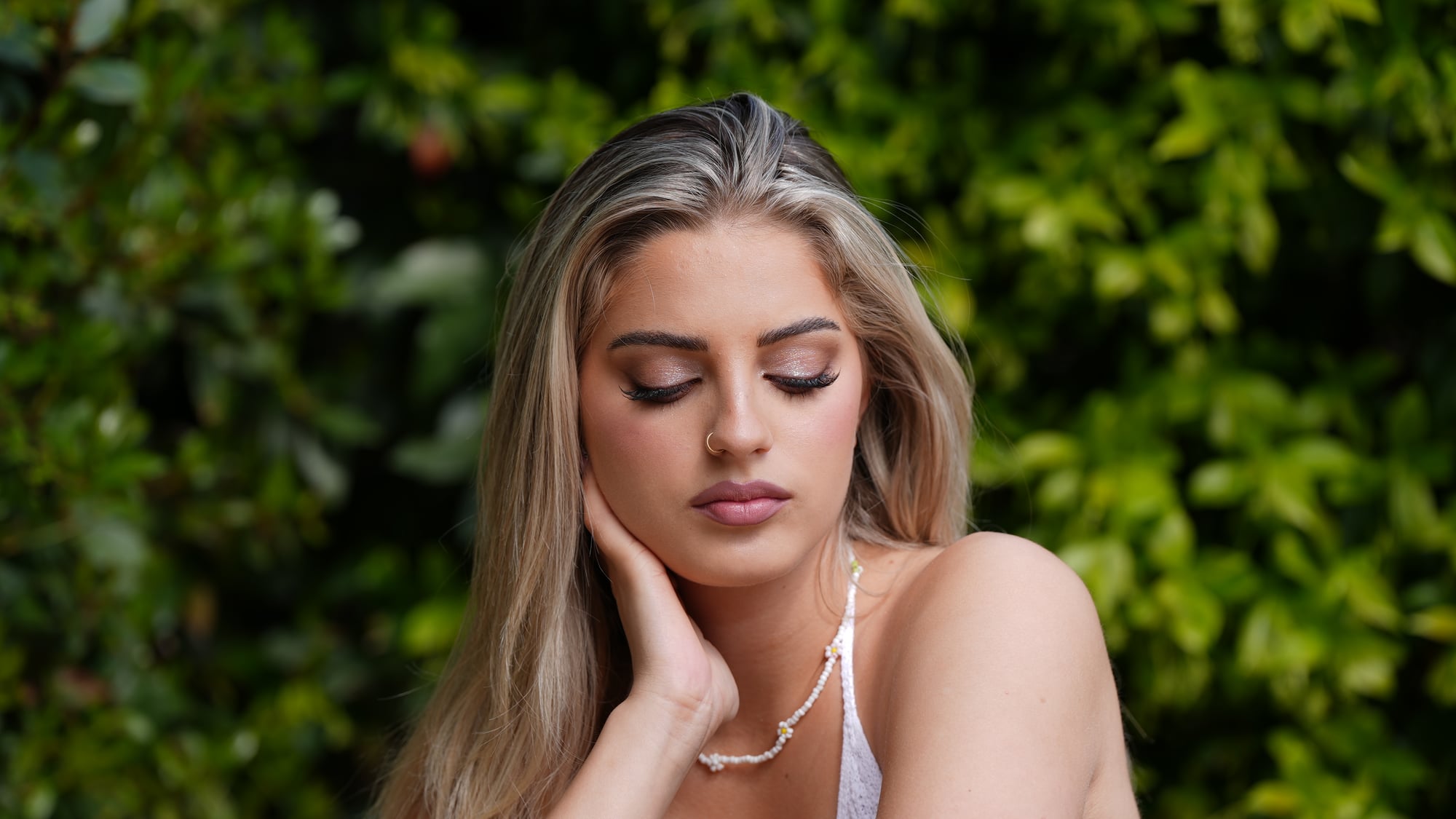 Portrait with relaxed expression in dappled light