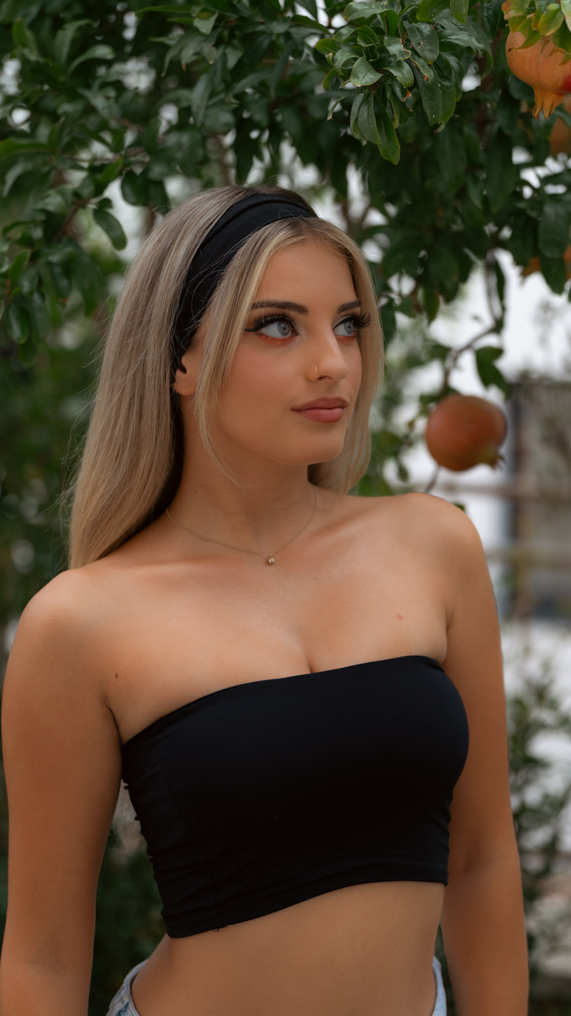 Portrait in open shade beneath a fruiting pomegranate tree