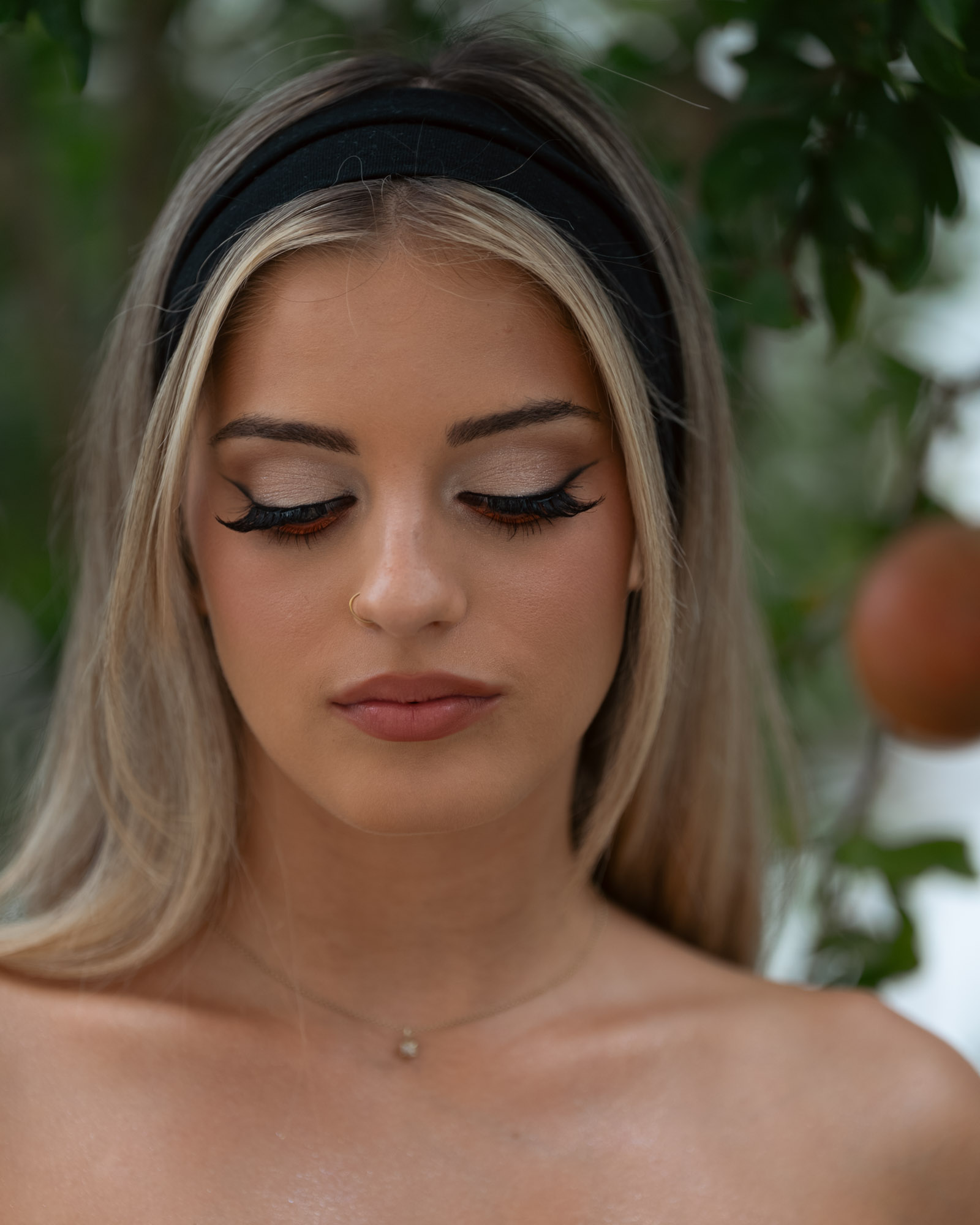 Close portrait with eyes closed, warm daylight on the skin
