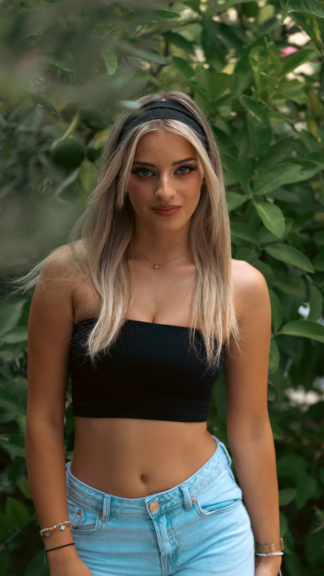 Portrait against a dense wall of green at the end of the garden