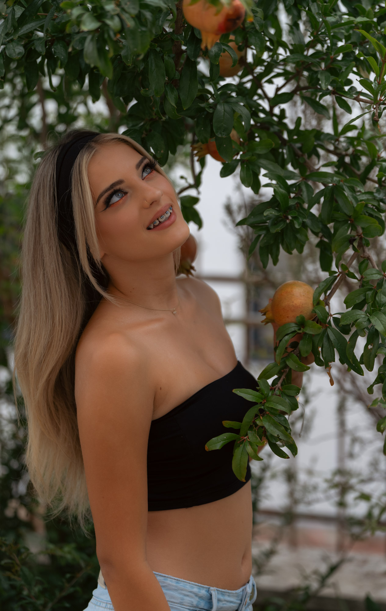 Portrait with a soft smile, gaze lifted away from camera