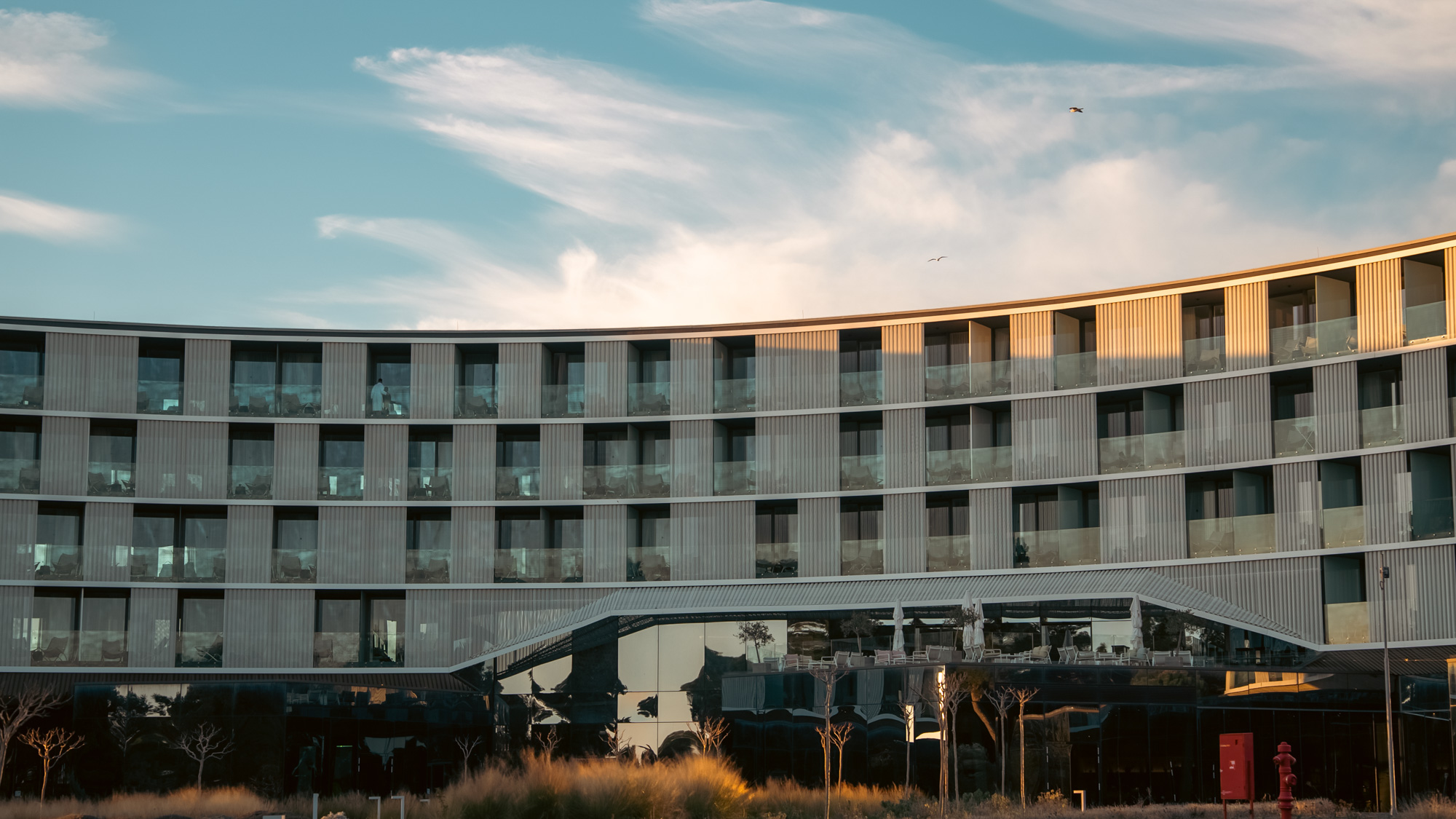 Amarin hotel facade with a guest walking past at dusk